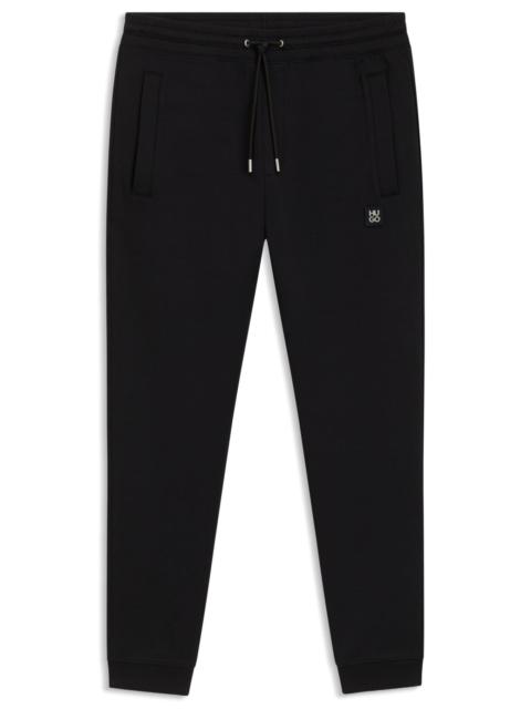 HUGO COTTON TRACKSUIT BOTTOMS WITH STACKED LOGO
