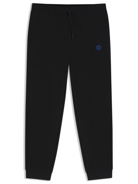 HUGO COTTON-TERRY TRACKSUIT BOTTOMS WITH HAPPY HUGO LOGO PATCH