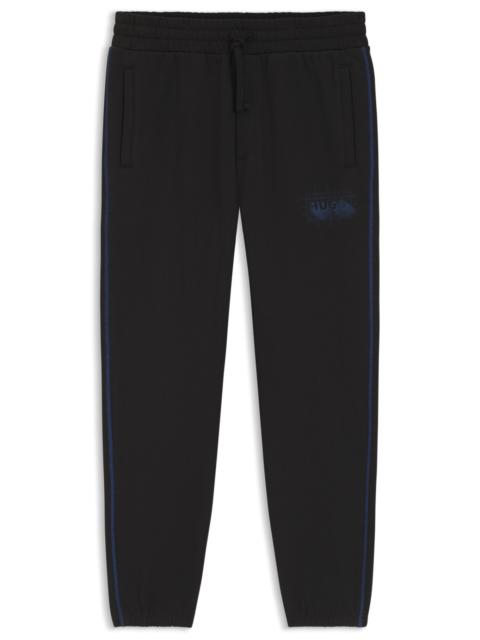 HUGO LOGO-ARTWORK TRACKSUIT BOTTOMS IN COTTON TERRY