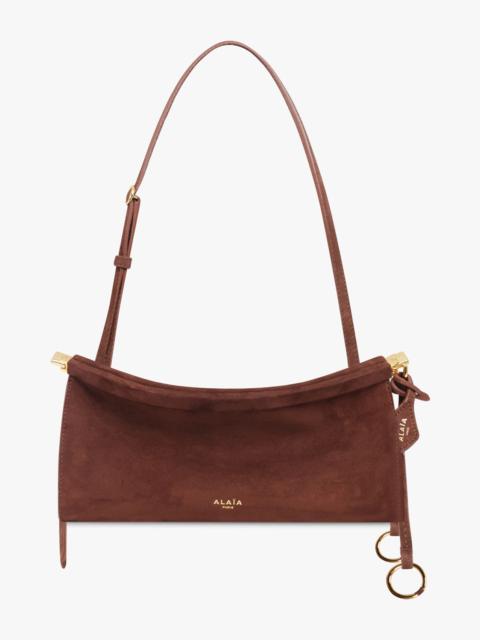 Alaïa LE CLICK EAST/WEST SMALL BAGUETTE SUEDE BAG | BROWN