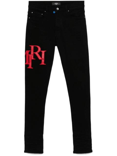 AMIRI Staggered-logo-embroidered jeans