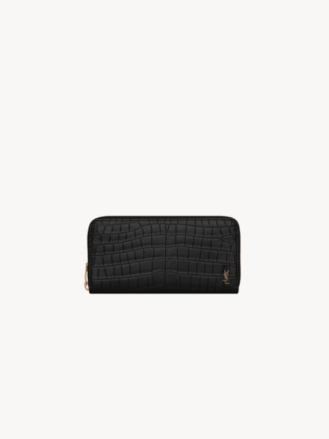 SAINT LAURENT TINY CASSANDRE ZIP-AROUND WALLET IN CROCODILE-EMBOSSED MATTE LEATHER