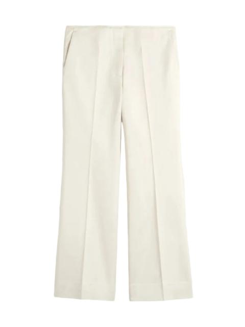 TOTEME Kick Flare Raw Edge Trousers in Stone