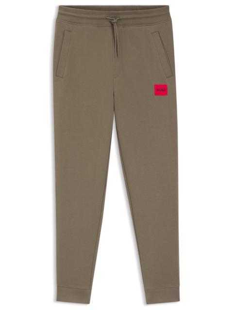 HUGO COTTON-TERRY TRACKSUIT BOTTOMS WITH LOGO LABEL