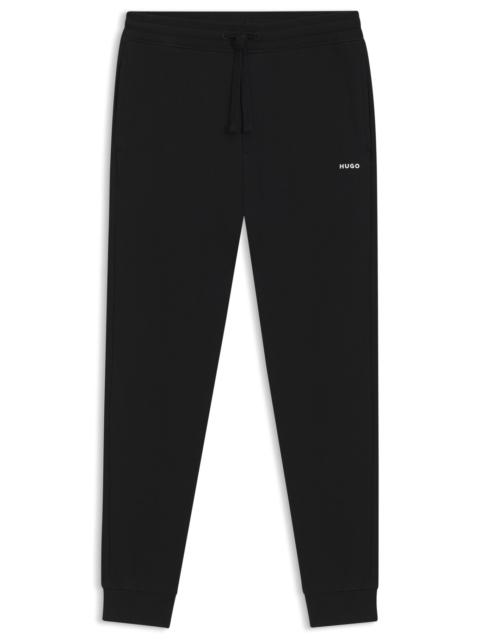 HUGO COTTON-TERRY TRACKSUIT BOTTOMS WITH LOGO PRINT