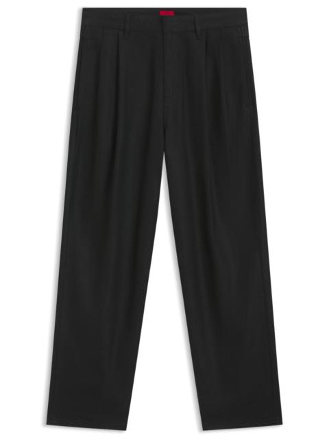 HUGO RELAXED-FIT JEANS IN BLACK WAXED DENIM