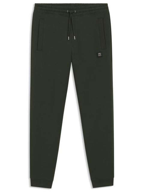 HUGO COTTON TRACKSUIT BOTTOMS WITH STACKED LOGO