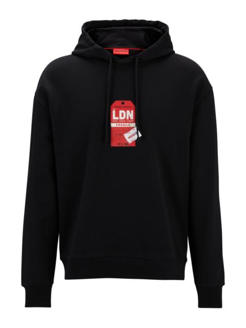 HUGO COTTON-TERRY HOODIE WITH TRAVEL-TAG ARTWORK