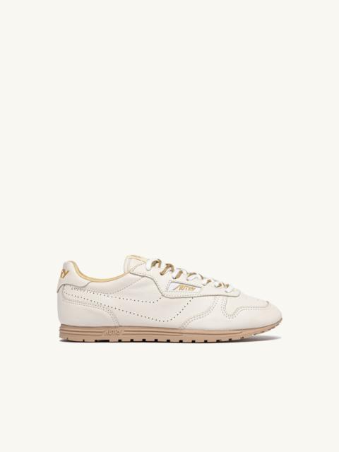 AUTRY WINDSPIN SNEAKERS IN WHITE AND GOLD NAPA LEATHER