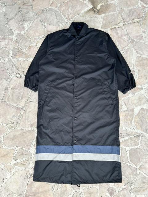 Comme Des Garçons Cdg black raincoat spellout on wrist