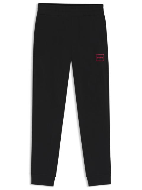 HUGO STRETCH-COTTON TRACKSUIT BOTTOMS WITH LOGO PRINT