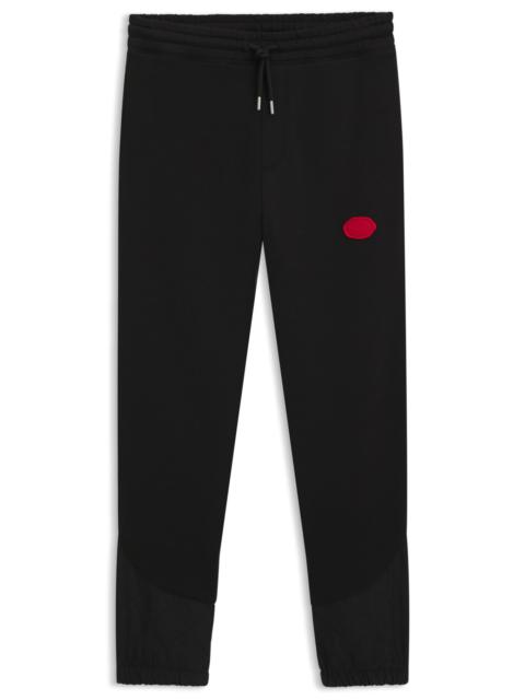 HUGO COTTON-BLEND TRACKSUIT BOTTOMS WITH WAXED-STAMP LOGO