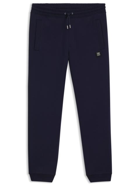 HUGO COTTON TRACKSUIT BOTTOMS WITH STACKED LOGO