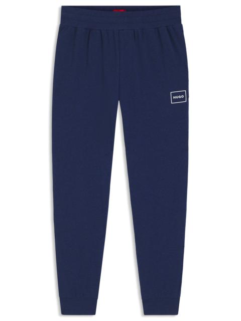 HUGO STRETCH-COTTON TRACKSUIT BOTTOMS WITH LOGO PRINT