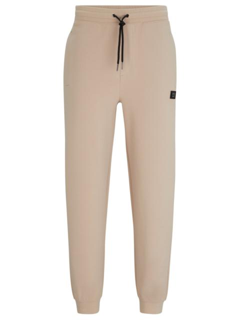 HUGO STRETCH-COTTON TRACKSUIT BOTTOMS WITH STACKED LOGO