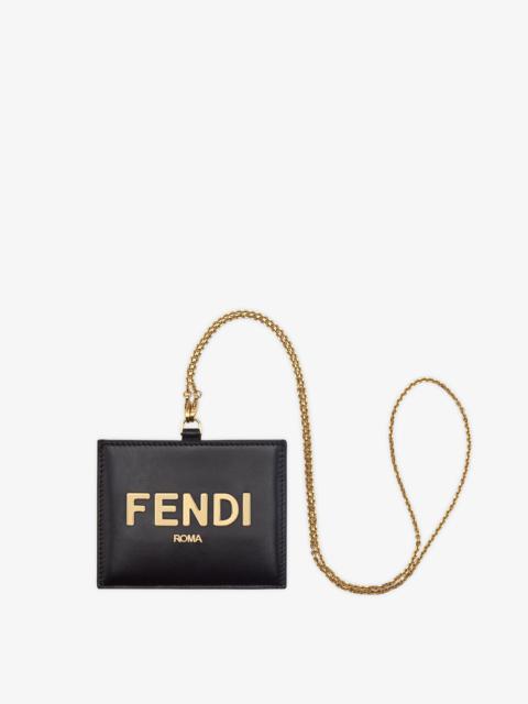 FENDI Fendi Roma name badge with a flat pocket and metal chain. Made of black leather. Gold-finish metalwa