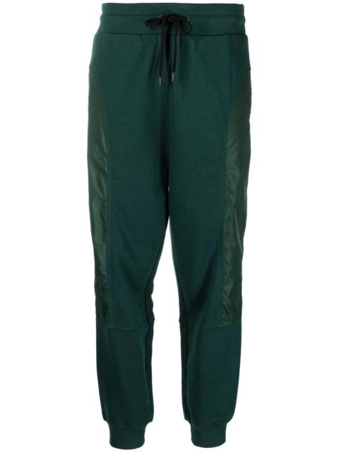 Moschino panelled logo-print track pants