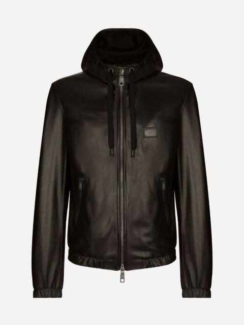 Leather jacket with hood and branded tag