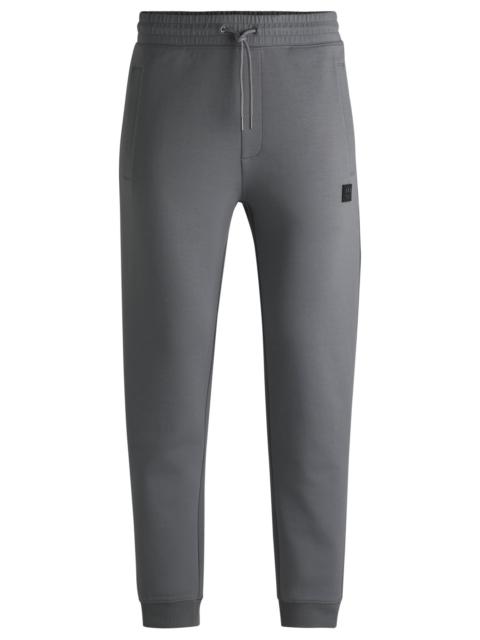 HUGO COTTON TRACKSUIT BOTTOMS WITH STACKED LOGO