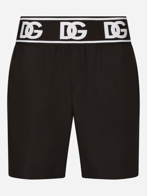 Mid-length swim trunks with branded elastic