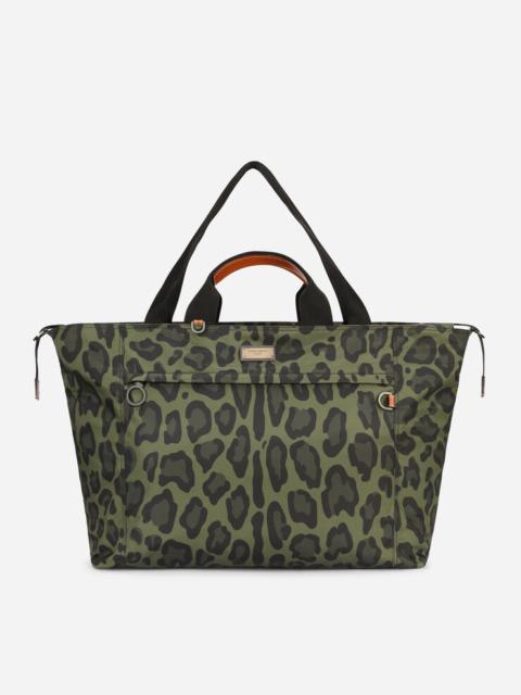 Dolce & Gabbana Nylon travel bag with leopard print against a green background and branded plate