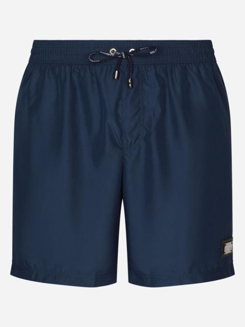 Long-leg swim trunks with branded tag