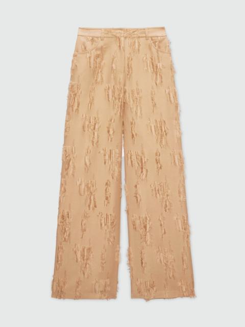 MSGM Beige wide-leg frayed fil coupe trousers.
