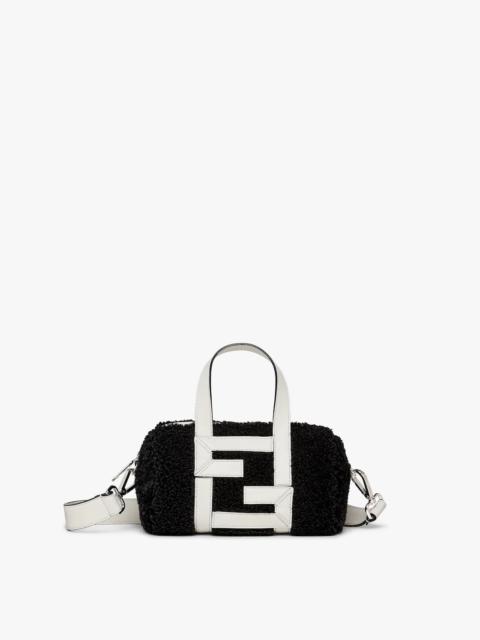 FENDI Mini bowling bag made of black sheepskin with white leather appliqués which create an FF motif. Line