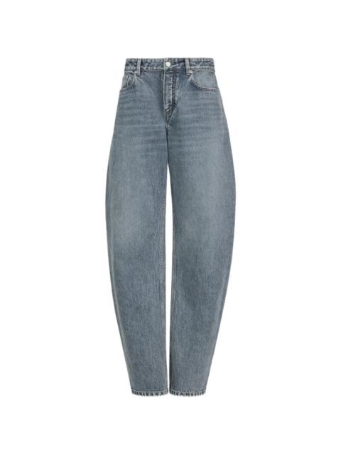 Alaïa faded-effect curved-leg jeans