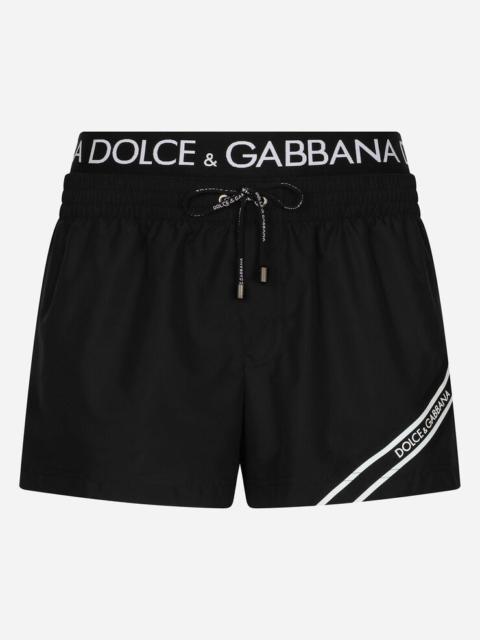 Short swim trunks with branded band