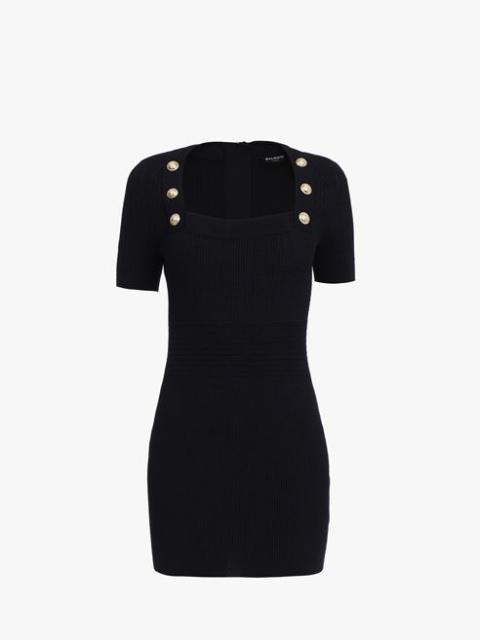 Short black knit dress with gold-tone buttons