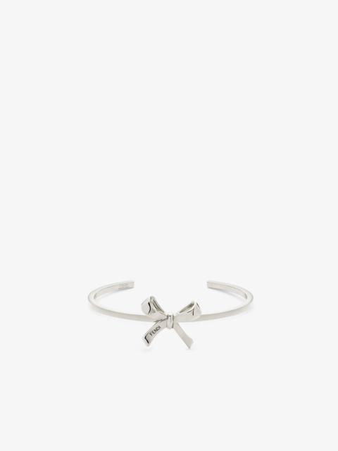 FENDI Rigid Bracelet with small bow. Made of palladium-finish metal. Decorated with Fendi lettering enamel