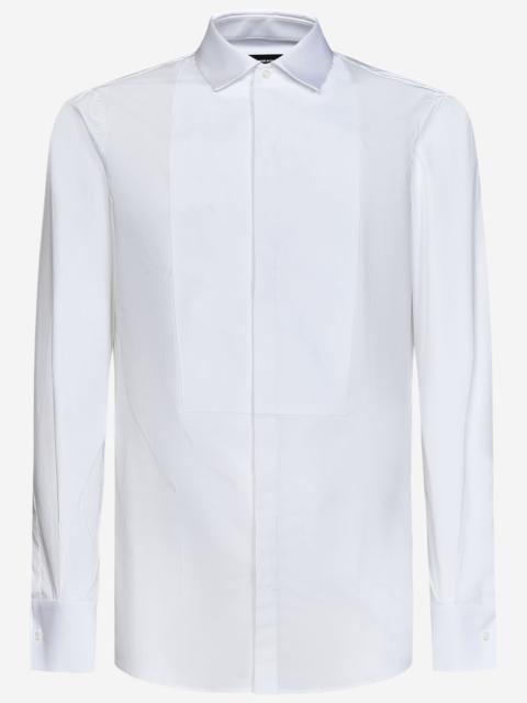 White cotton shirt with plastron and hidden front closure.