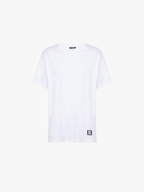 Oversized white eco-designed cotton T-shirt with black Balmain logo print