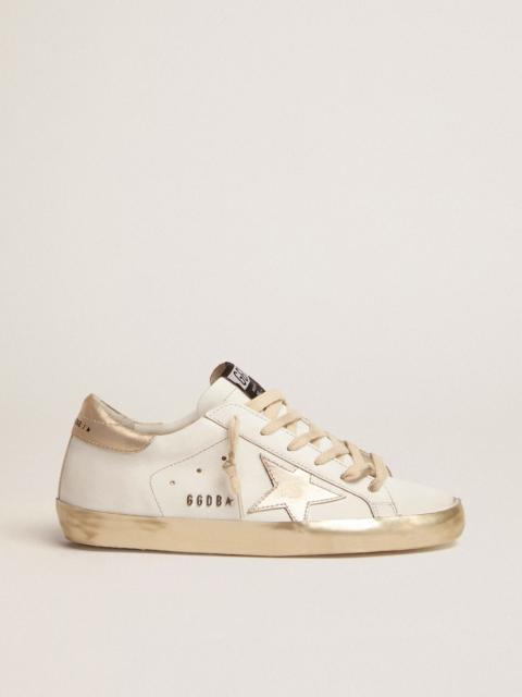 Golden Goose Women’s Super-Star sneakers with gold sparkle foxing and metal stud lettering