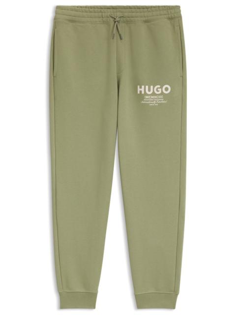 HUGO LOGO-PRINT TRACKSUIT BOTTOMS IN COTTON TERRY
