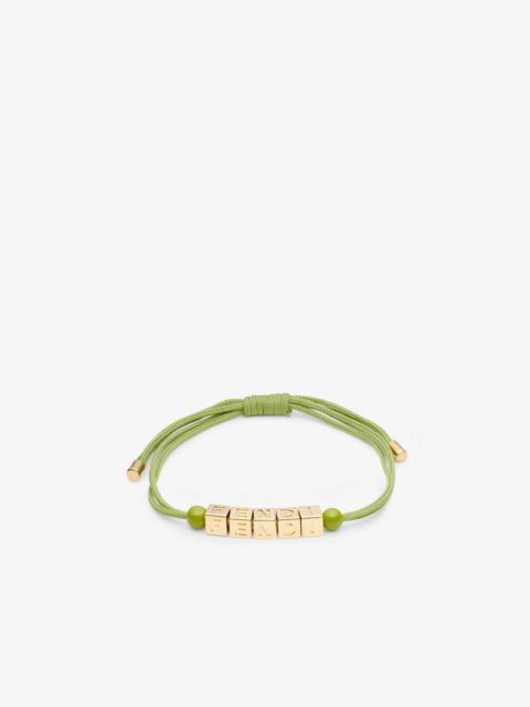 FENDI Bracelet with small cubes that create the Fendi lettering. Fine acid green cord and orbs in tone on 
