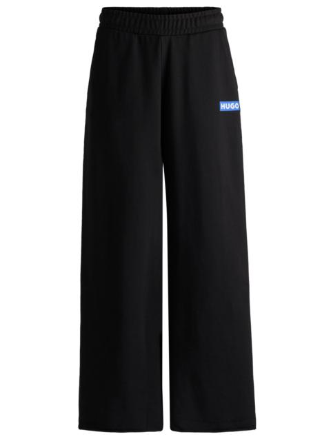 HUGO RELAXED-FIT TRACKSUIT BOTTOMS WITH LOGO PRINT