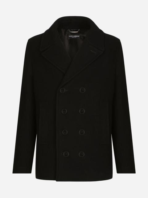 Double-breasted wool pea coat with branded tag