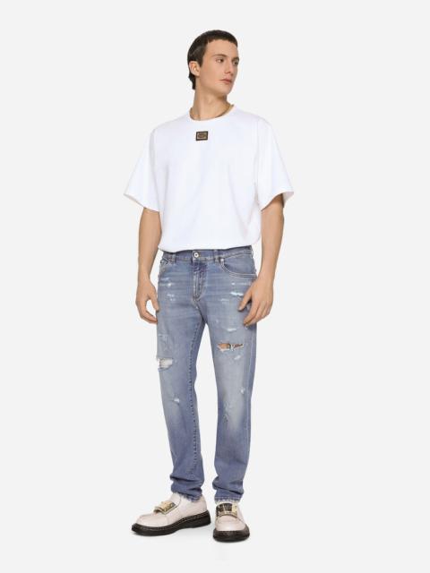 Light blue slim-fit stretch jeans with rips