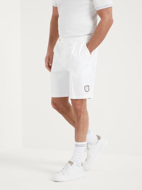 Chalk stripe nylon pleated Bermuda shorts with tabbed waistband and tennis badge