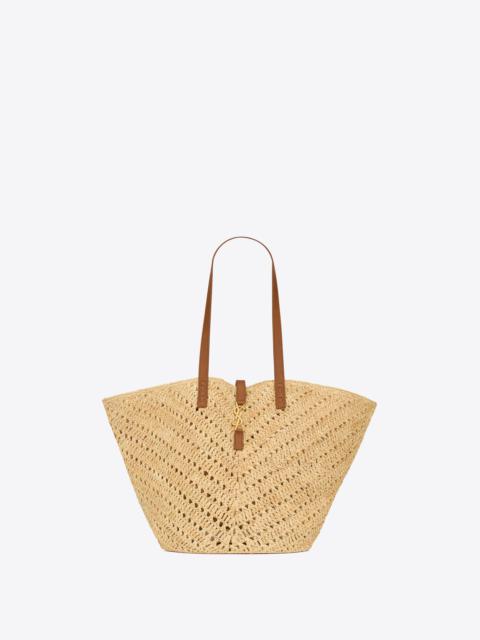 SAINT LAURENT panier medium in raffia and vegetable-tanned leather