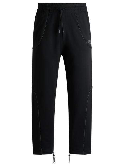 HUGO COTTON-TERRY TRACKSUIT BOTTOMS WITH DECORATIVE REFLECTIVE TRIMS