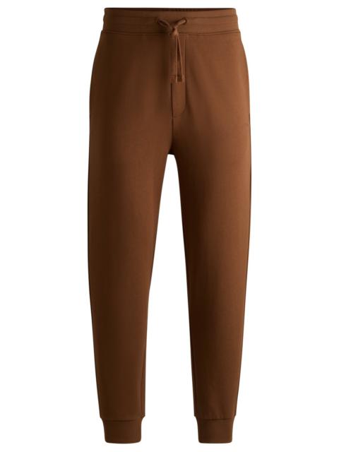 HUGO COTTON-TERRY TRACKSUIT BOTTOMS WITH LOGO PRINT
