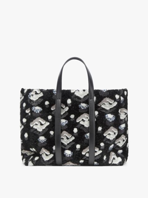 FENDI Roomy shopper made of soft curly sheepskin with FF inlay in black, gray and white. Features a fabric