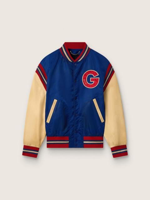 Golden Goose Men's blue varsity bomber jacket with beige leather sleeves
