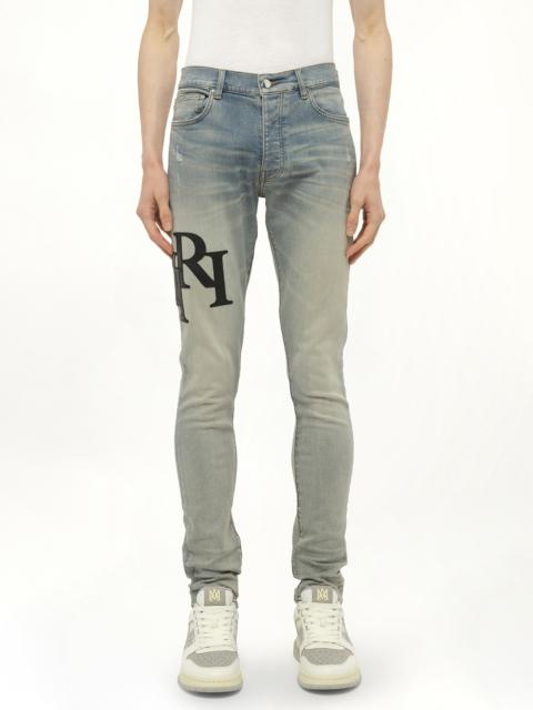 AMIRI Staggered Logo Skinny Jeans in Antique Indigo/Black