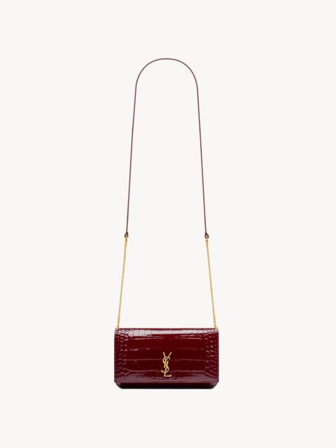 SAINT LAURENT CASSANDRE PHONE HOLDER IN CROCODILE-EMBOSSED PATENT LEATHER