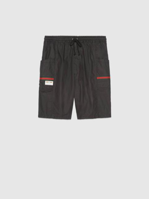 GUCCI Coated cotton shorts with Gucci label