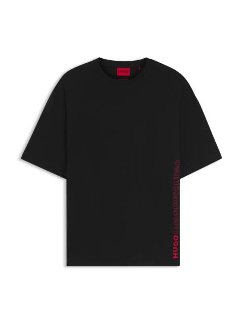 HUGO OVERSIZED-FIT COTTON T-SHIRT WITH ALL-OVER LOGO PRINT